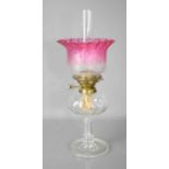 A 19th century glass oil lamp, the font of curved, fluted form, on circular column to pedestal base,