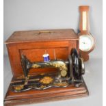 An antique Singer Sewing machine, with original case, together with a barometer.