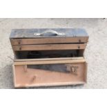 A vintage carpenters tool box with contents to include, saws, drills, planes and other items.