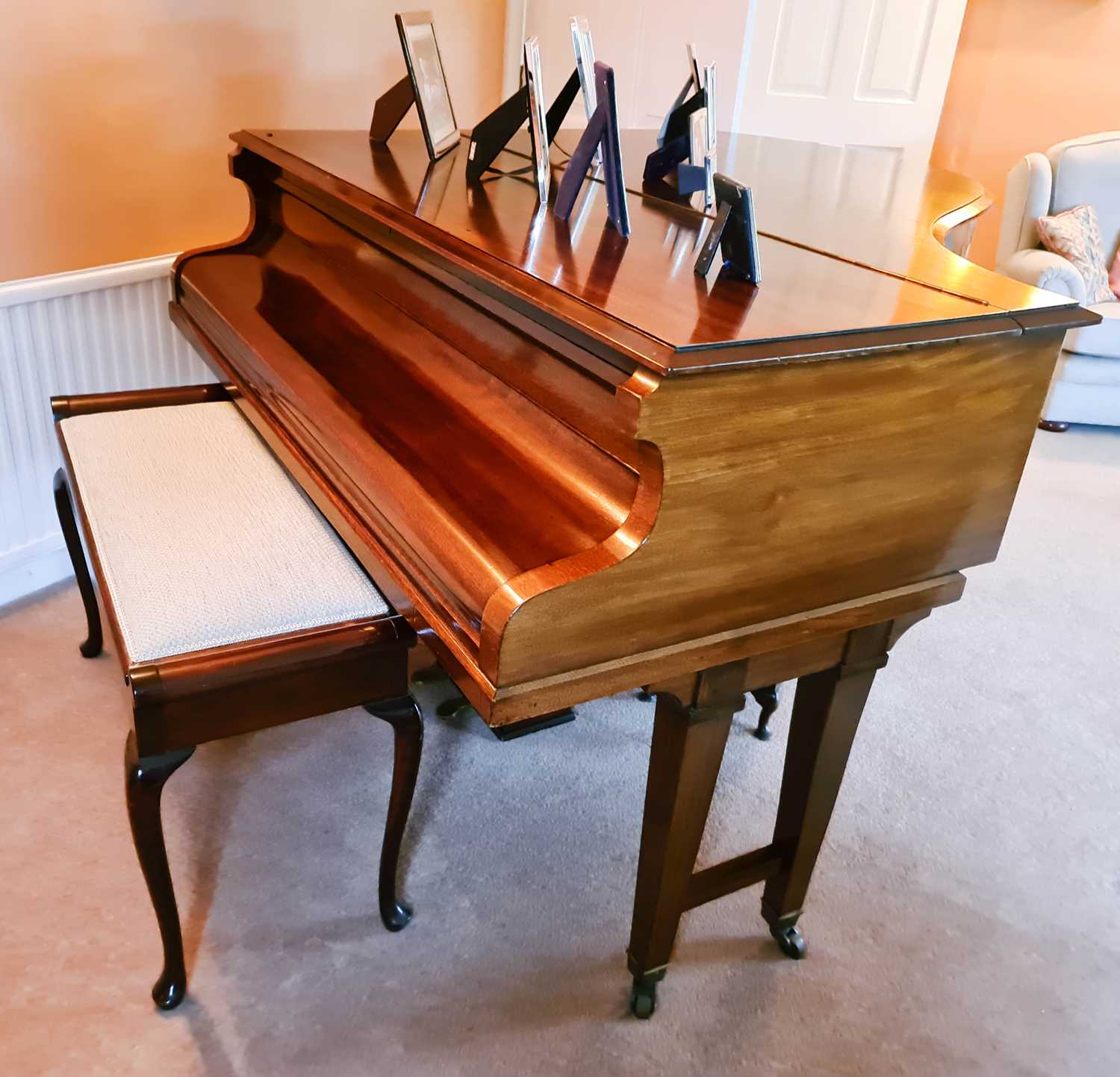 A John H Crowley of London baby grand piano, in a mahogany case, the lid lifts to reveal a
