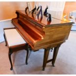 A John H Crowley of London baby grand piano, in a mahogany case, the lid lifts to reveal a