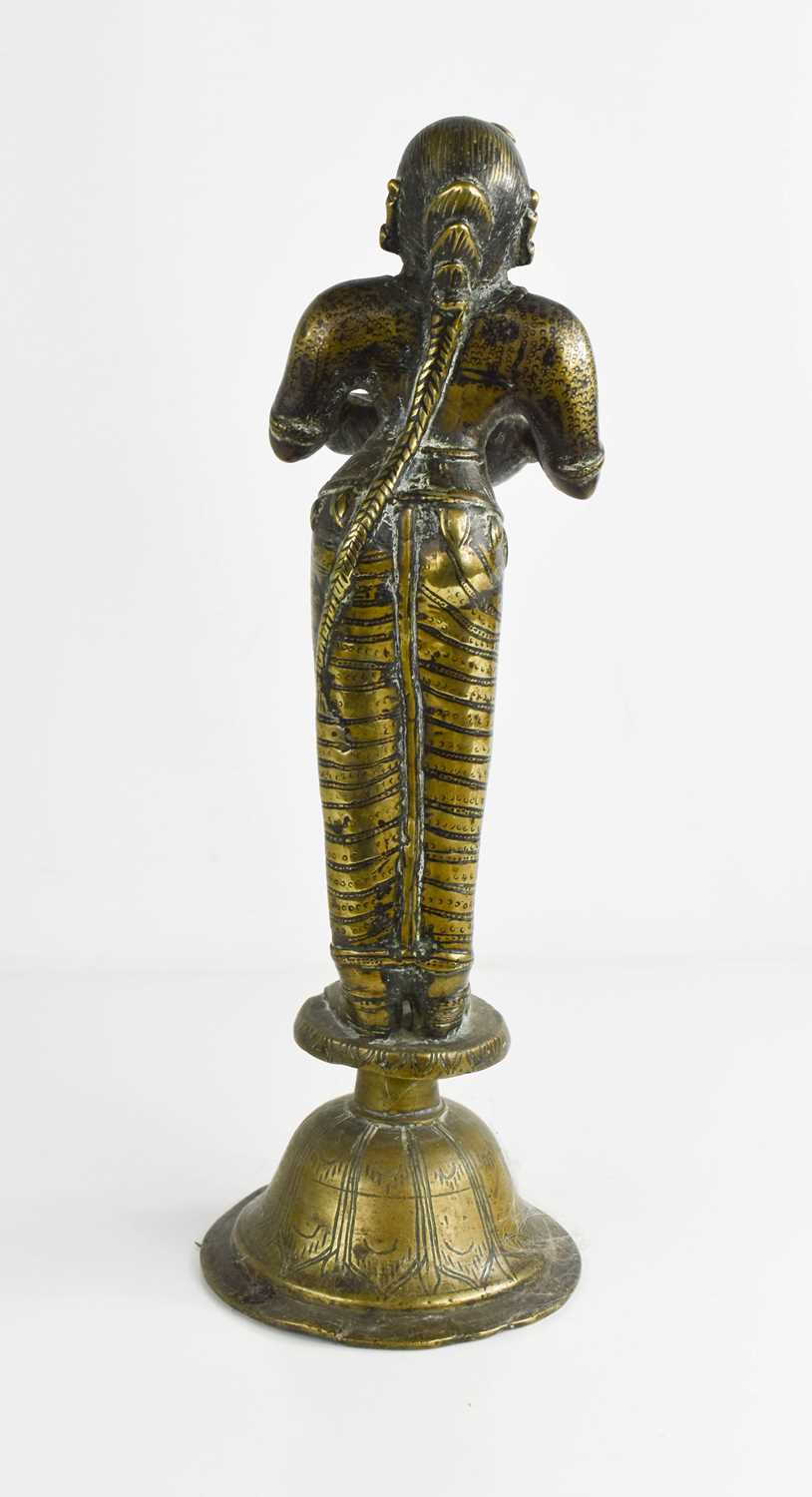 A 19th century Indonesian brass sculpture of a woman holding a bowl, raised on a bell form base, - Bild 3 aus 3