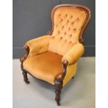 A Victorian mahogany framed nursing chair, upholstered in ochre coloured velor, button back and