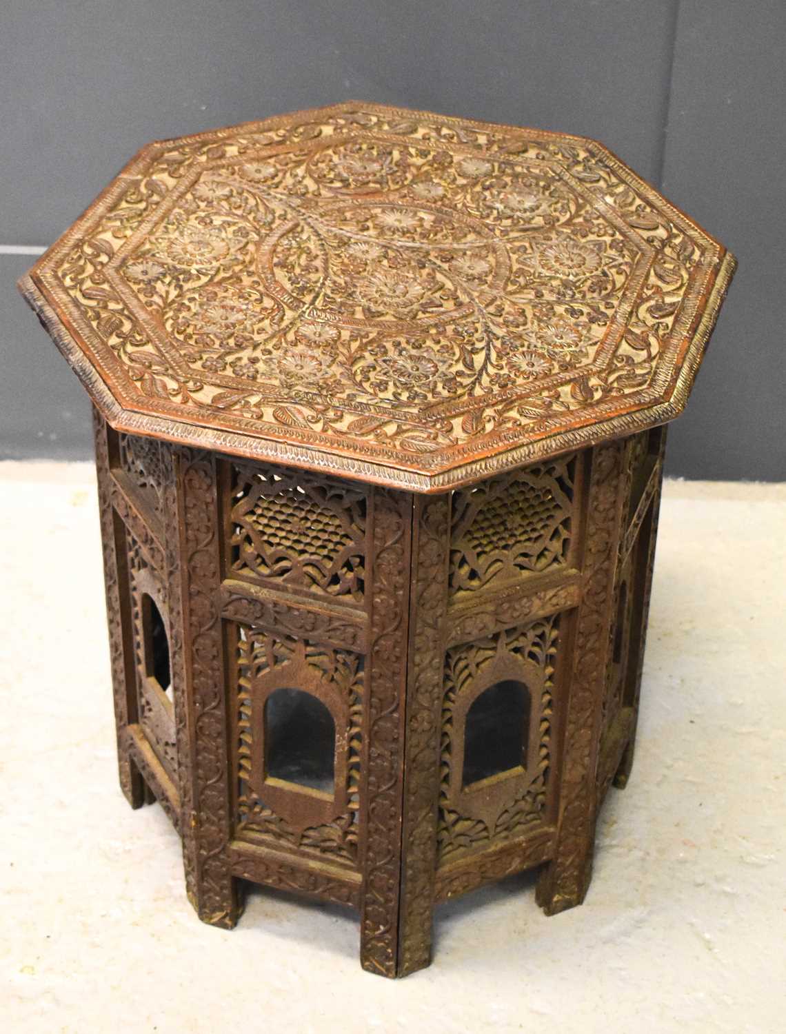 A small Indian carved table with folding base composed of pierced decorative panels and having an - Image 2 of 2