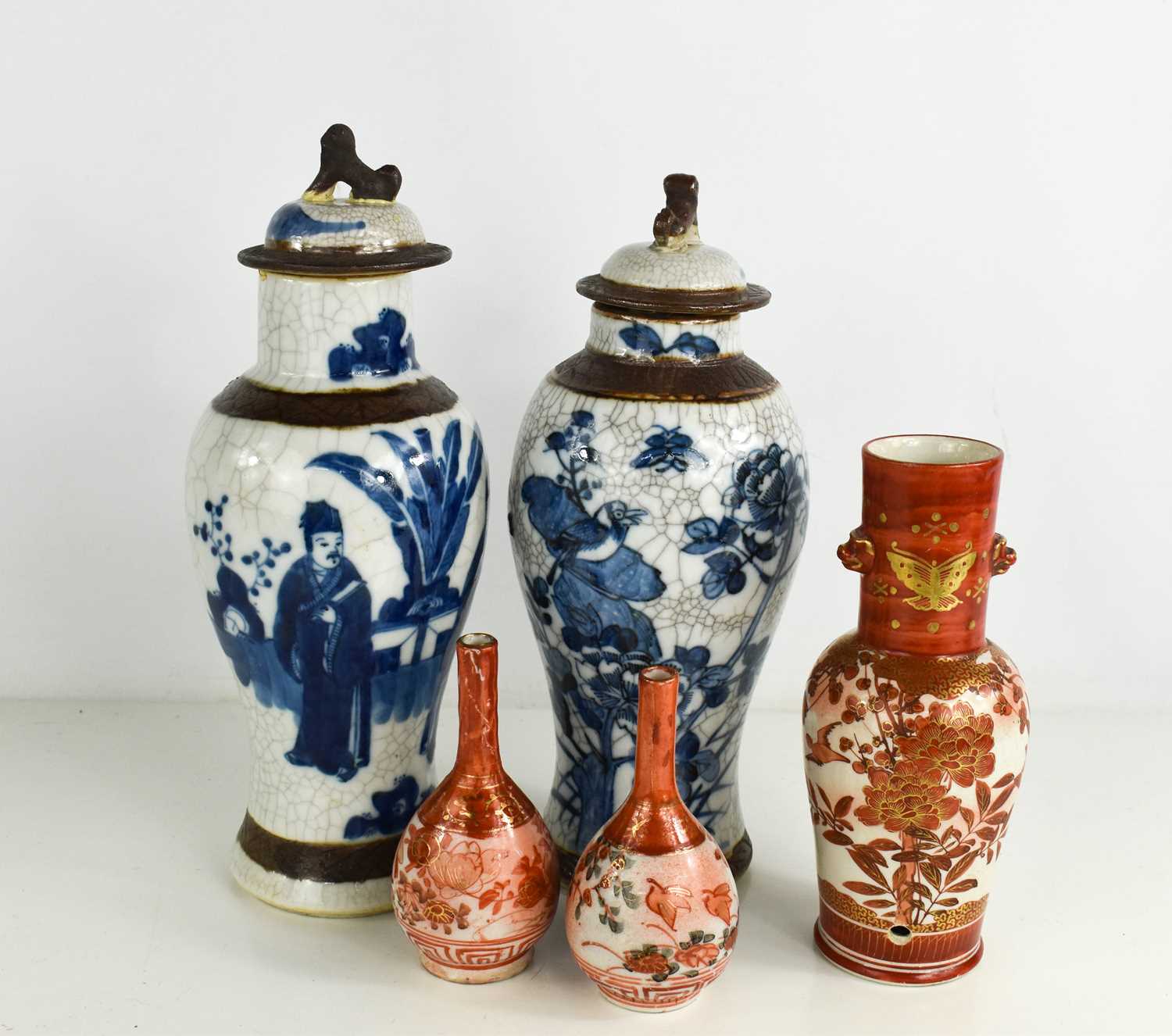 Two Chinese blue and white stoneware jars and covers, together with two bottle vases and a drilled