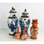 Two Chinese blue and white stoneware jars and covers, together with two bottle vases and a drilled