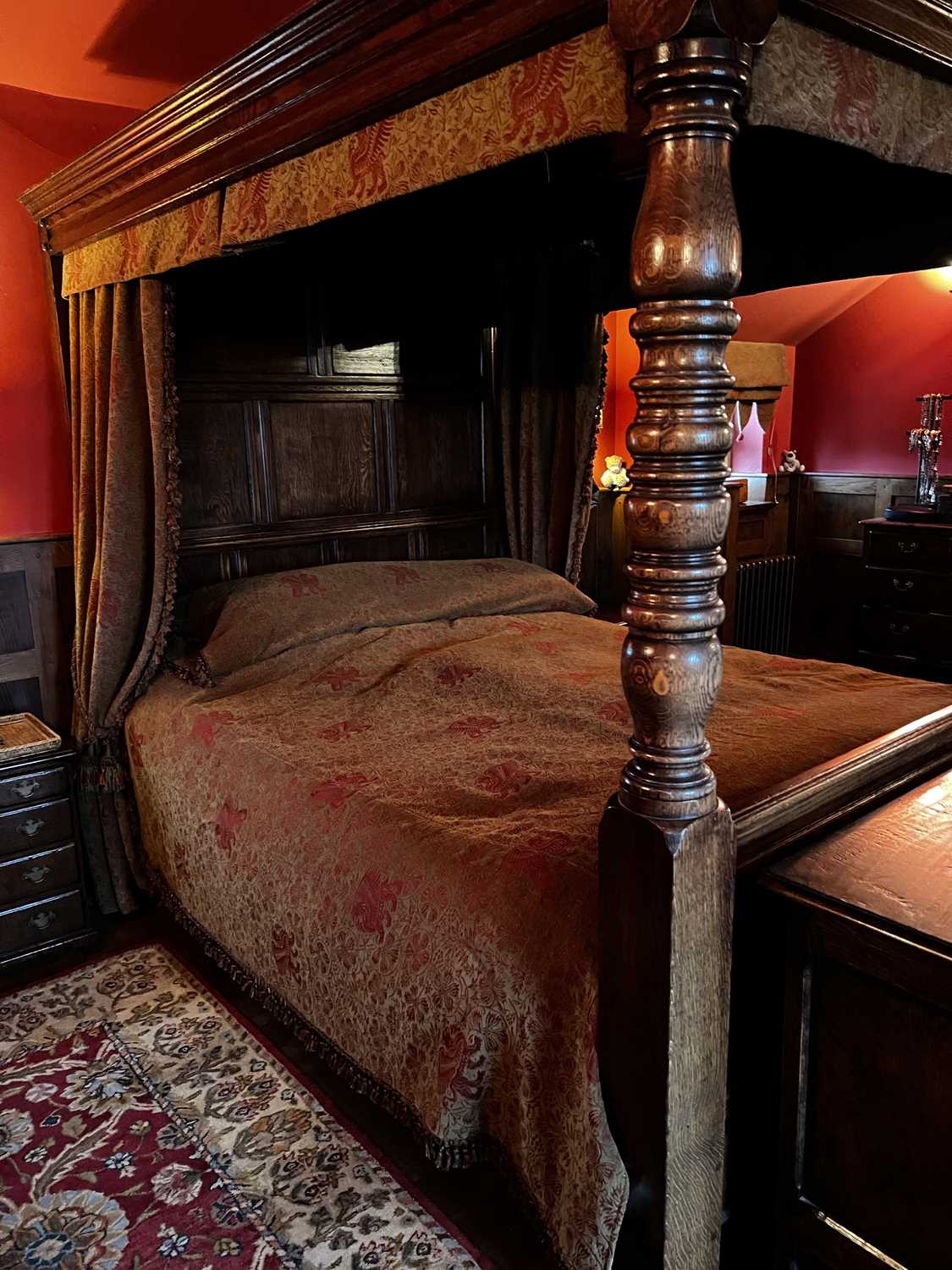 An oak four poster double bed, together with the drapes and matching bedspread, the full canopy