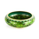 An early 20th century Chinese champleve enamel bowl in various tones of green to depict flowers