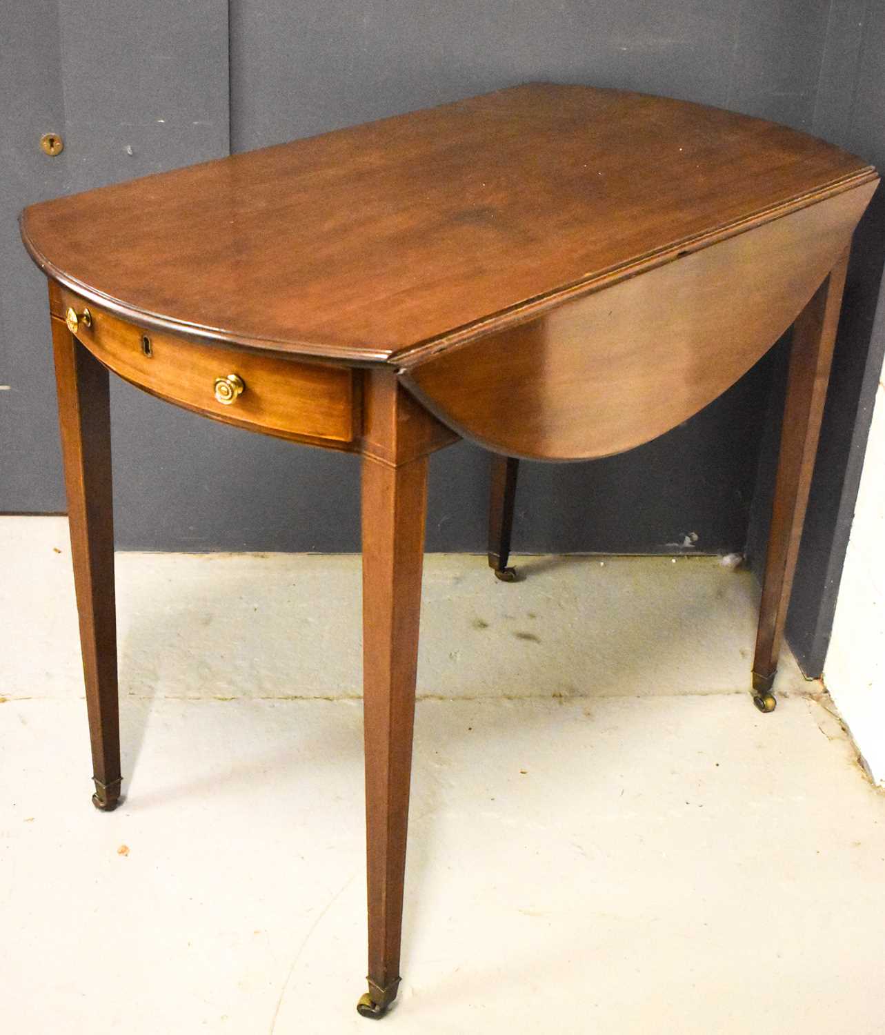 A 19th century mahogany Pembroke table with single drawer on sqaure tapered legs and brass