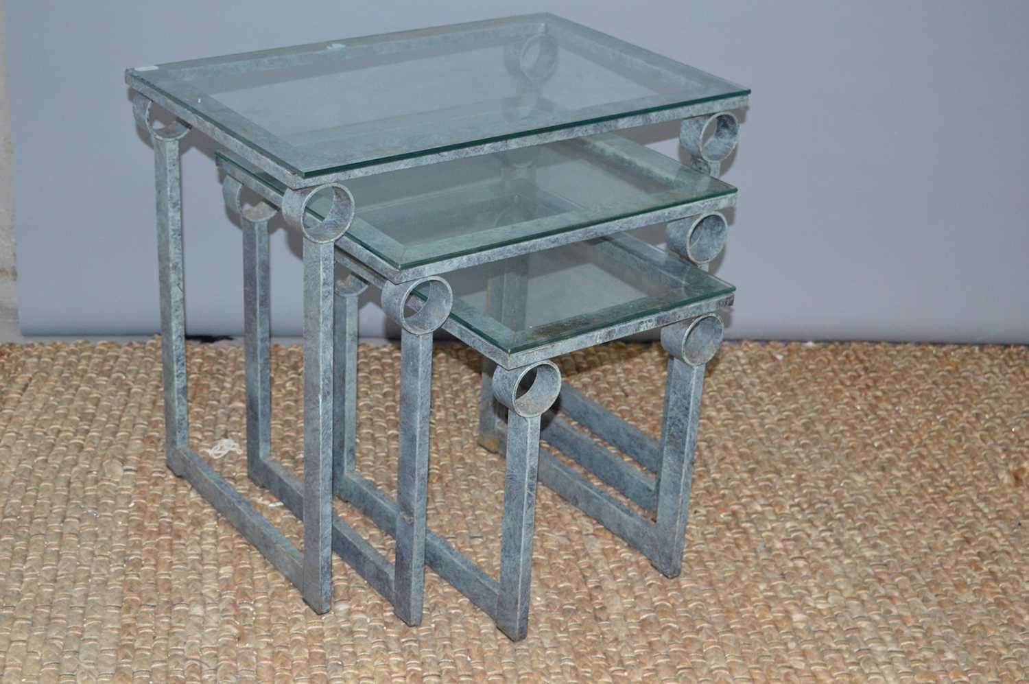 A nest of three Italian design tables, metalwork frames.