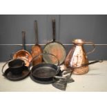 A group of antique copper and iron ware to include a large copper measure, strainer, skillet and pan