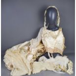 An early 20th century ivory silk wedding dress comprising corset, skirt with net trim and