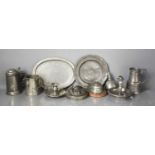 A collection of pewter to include oval plater, plate, lidded tankard, chamber sticks, jelly mould,