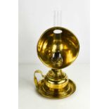A 19th century oil lamp with a light reflective dome over a glass inner shade.