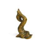 A small bronze ornament in the form of a classical Greek dolphin.