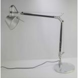An Artemide anglepoise desk lamp.