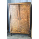 An early 20th century French burrwood cabinet with two doors enclosing shelved interior raised on