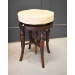 A 19th century mahogany piano stool with circular height adjustable seat, with screw mechanism.