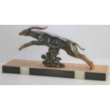 An Art Deco spelter leaping gazelle signed 'Limousin' upon a rectangular marble base, width 70cm