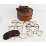 Six pairs of late 19th / early 20th century glasses and pince nez, together with a leather collar