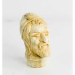 A 19th century Italian horn carved cane top, in the form of a bearded gentleman, 5½cm high.