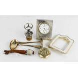 A silver framed RJ Carr clock, Mercedes white metal bottle stopper, mirrored powder pot, and
