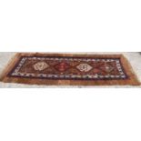 A 19th century Middle Eastern wool hand woven runner with four central motifs with geometric