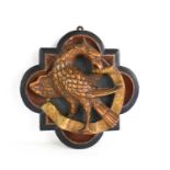 A 19th century carved polychrome quatrefoil plaque depicting an eagle and scroll, 23cm high.