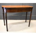 A Regency mahogany fold over top tea table with crossbanded top on reeded tapered legs, 92cm by 91.