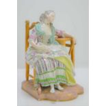 A late 19th century Meissen porcelain figure of a lady asleep at the table, 20cm high, a/f