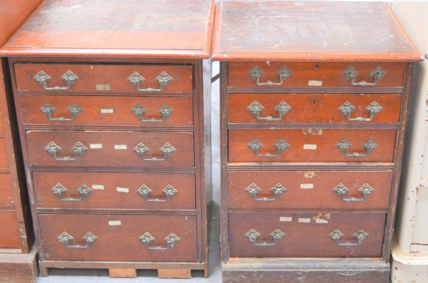 A pair of 19th century oak sets of drawers, six deep graduated drawers having decorative handles and