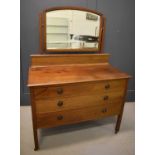 An Edwardian mahogany dressing table with a mirrored back and three drawers together with a mahogany
