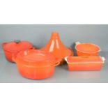 Four Le Creuset cast iron cooking pots to include casserole dishes together with a stoneware cooking