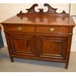 An Edwardian mahogany sideboard with a shaped and pierced backrail.