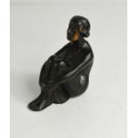 An Art Deco bronze car mascot in the form of a seated lady, 9½cm high.