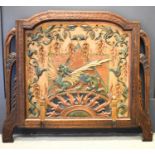 An Art Nouveau period carved polychrome panel in an oak frame, the panel depicting a dragon with