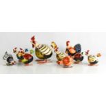 A collection of nine Gallo ceramic rocking roosters and hens.