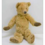 An early 20th century mohair teddy bear possibly by Steiff, 40cm tall.