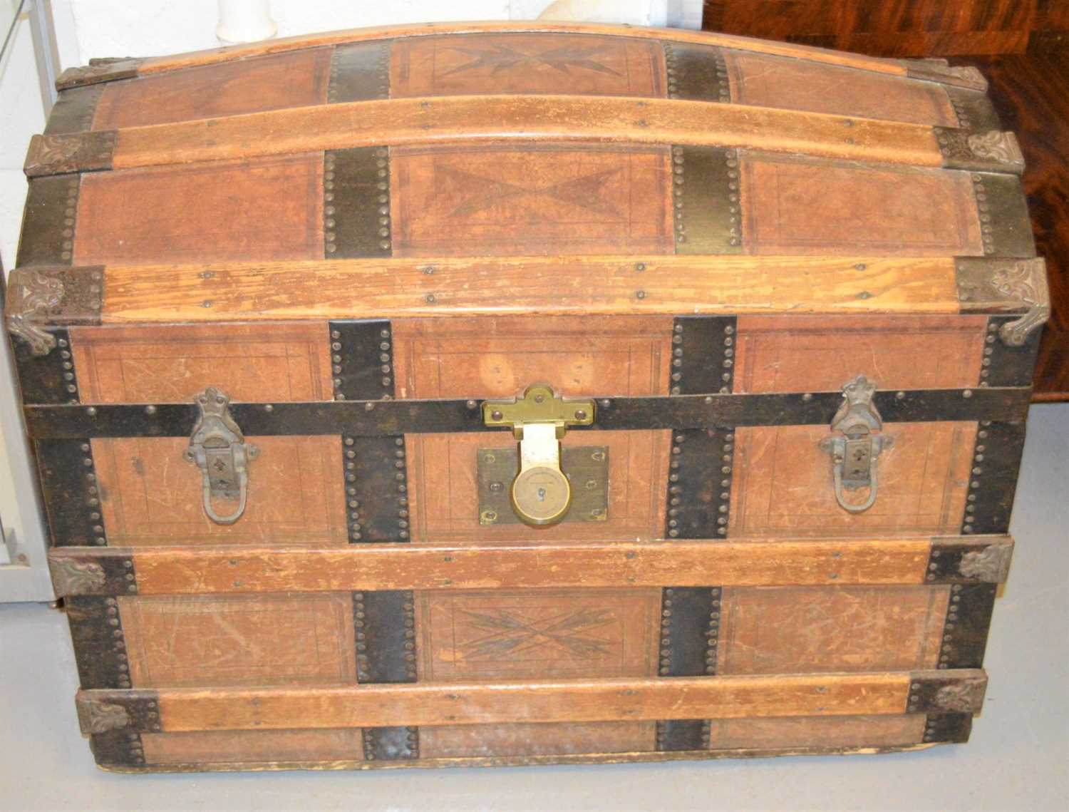 An antique dome top traveling trunk clad in leather and metal work straps, twin leather handles - Image 2 of 2