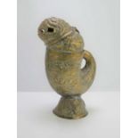 A late 19th century Indian embossed brass jug in the form of a mythological fish, allover fish and