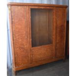 An early 20th century French burrwood cabinet, the central door having a grille panel opening to