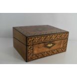 A 19th century parquetry workbox, with interior slope, ink well and pen holder, 14 by 30 by 23cm.