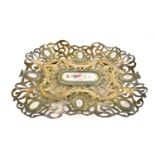 A silver plated porcelain and silver plated dish, decoratively pierced and engraved and inset with