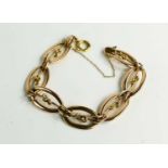 A rolled rose gold oval link bracelet with spare link and original clasp, 15.45g.