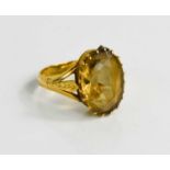 A gold ring set with oval smoky quartz, 14.4 by 10mm, the shank with Chinese character marks, and