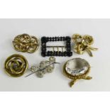 A group of five vintage brooches, comprising a large brooch set with oval crystal, 33.5 by 28mm,