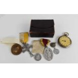 A pocket watch together with a group of medals and leather pouch.