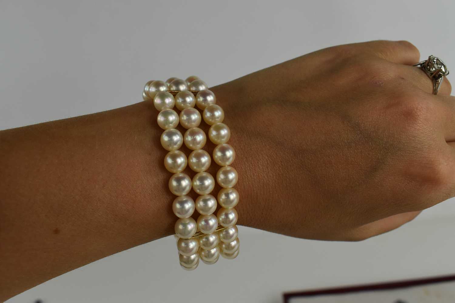 An 18ct gold and three strand pearl bracelet, by Leo de Vroomen, London 1984, the strands gathered - Bild 5 aus 5