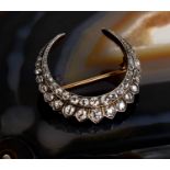 A stunning French diamond and gold crescent form brooch, set with thirty eight graduated brilliant