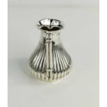A Christopher Dresser influenced silver cream jug with reeded body and angular handle, Birmingham